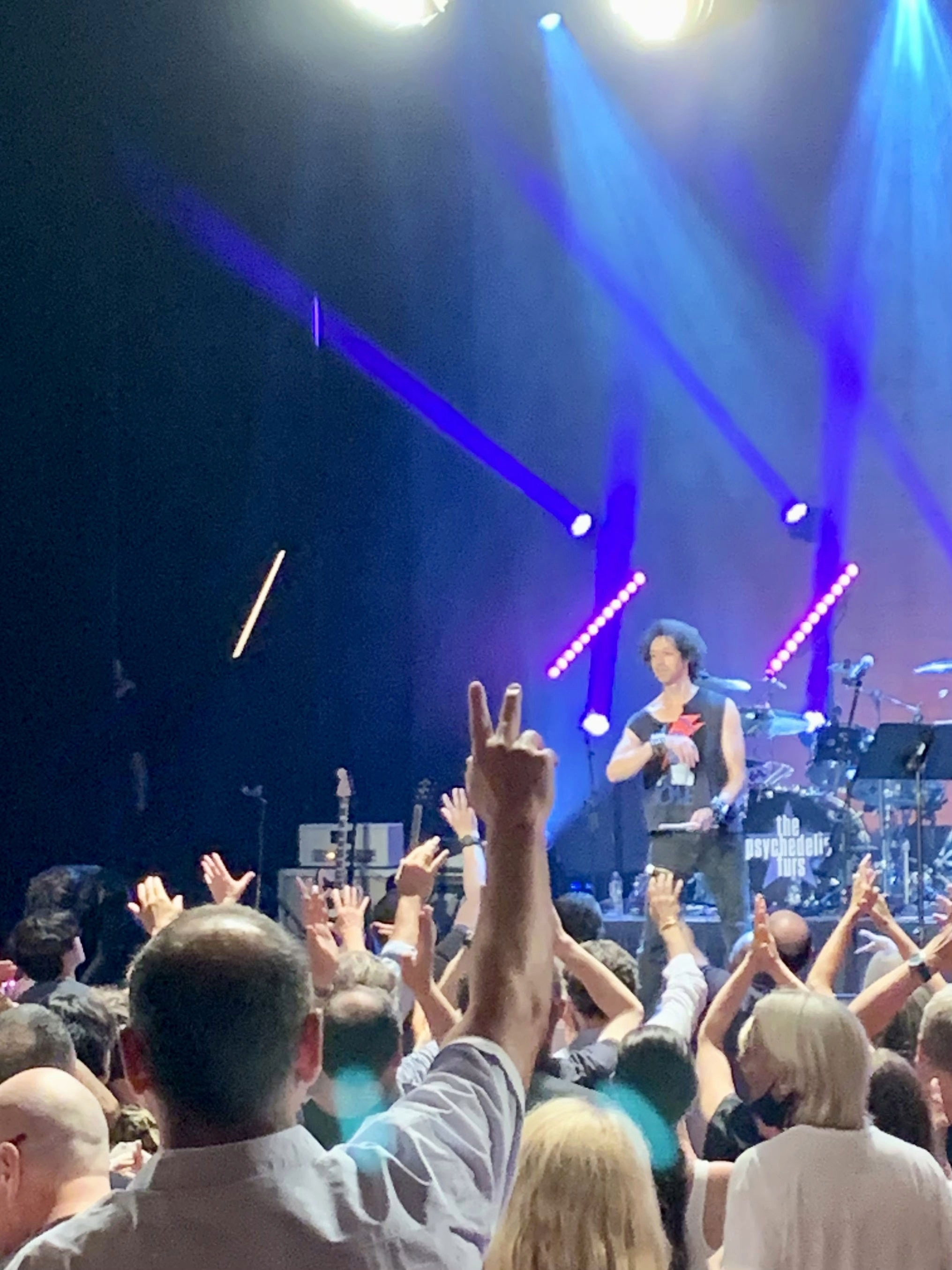 Zachary Alford stands on stage at the New York's Apollo Theater and throws his drumstick into the audience.